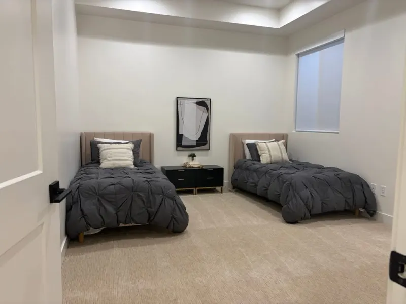 Tidy twin bedroom suite after a cleaning visit