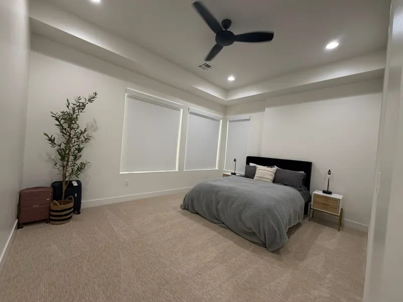 Freshly cleaned master bedroom with a made bed