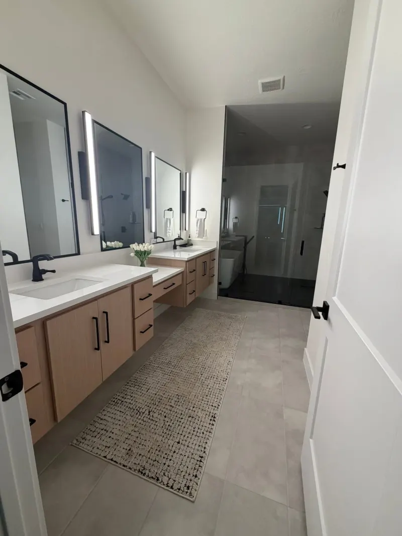 Clean master bathroom with polished counters and mirrors